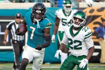 Jacksonville Jaguars wide receiver Brian Thomas Jr. (7) runs past New York Jets safety Tony Ada ...