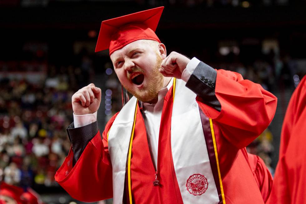 A graduate cheers toward a video camera during the UNLV winter commencement at the Thomas & ...