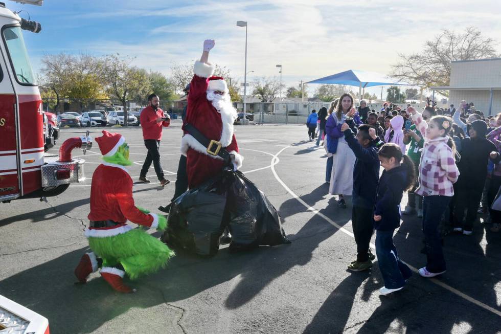 Kids react after Santa Claus got back bags of toys the Grinch was trying to steal as local fire ...