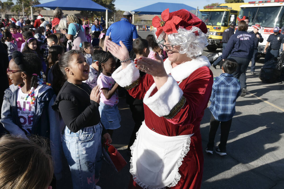 Kids react as Mrs. Claus Arrives with area firefighters to deliver toys at Will Buckley Element ...