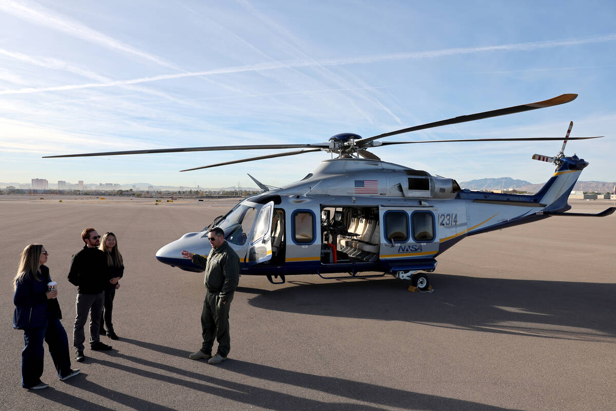 Pilot and Aviation Department Manager Mike Toland, right, talks to the crew of a new U.S. Depar ...