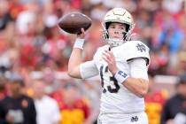 Notre Dame quarterback Riley Leonard throws during the first half of an NCAA college football g ...