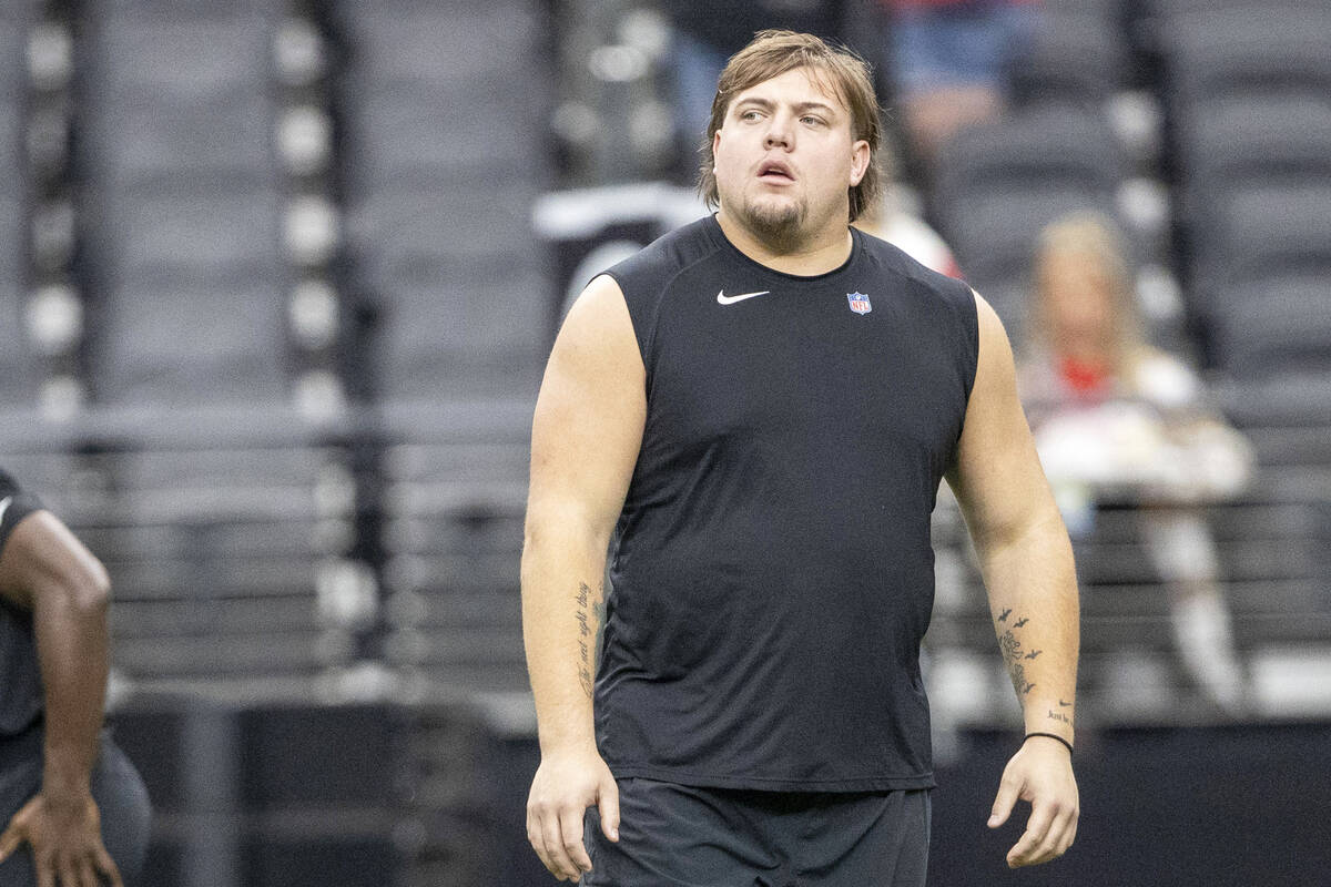 Raiders guard Jackson Powers-Johnson on the field for early warm-ups before an NFL game against ...