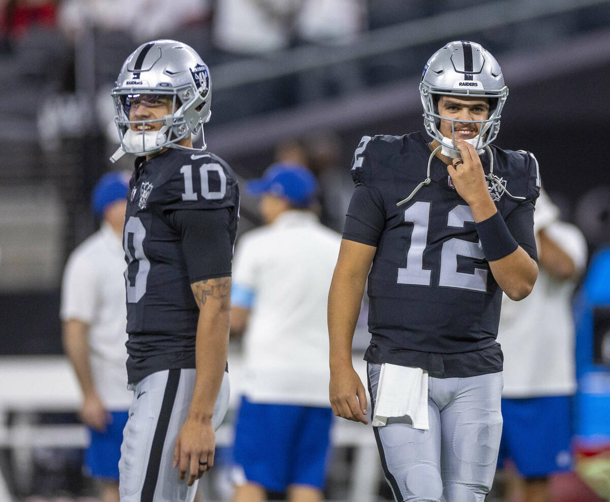 Raiders quarterback Desmond Ridder (10) and quarterback Aidan O'Connell (12) together during wa ...