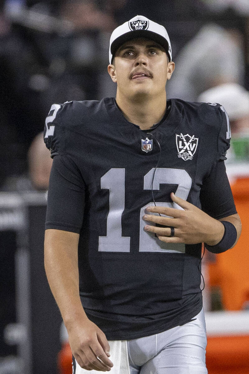 Raiders quarterback Aidan O'Connell (12) on the sideline during the first half of an NFL game a ...