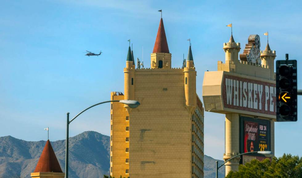 A helicopter cruises beyond the Whiskey Pete's Hotel & Casino on Friday, Jan. 26, 2024, in ...