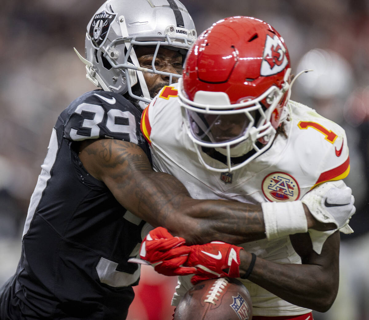 Raiders cornerback Nate Hobbs (39) tackles Kansas City Chiefs wide receiver Xavier Worthy (1) d ...