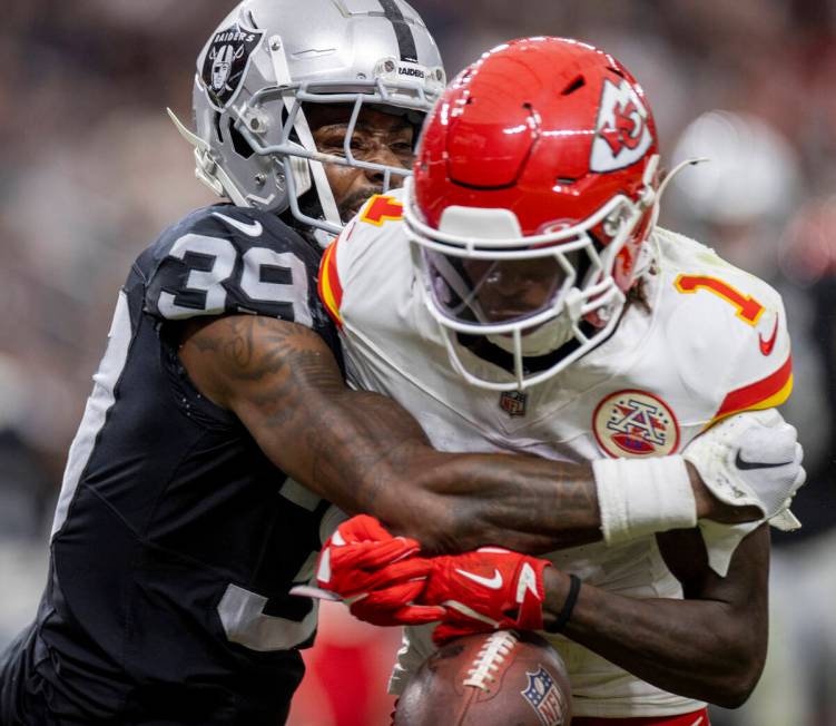 Raiders cornerback Nate Hobbs (39) tackles Kansas City Chiefs wide receiver Xavier Worthy (1) d ...