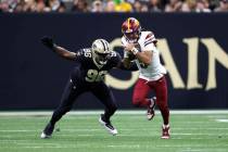 Washington Commanders quarterback Jayden Daniels (5) runs the ball in front of New Orleans Sain ...