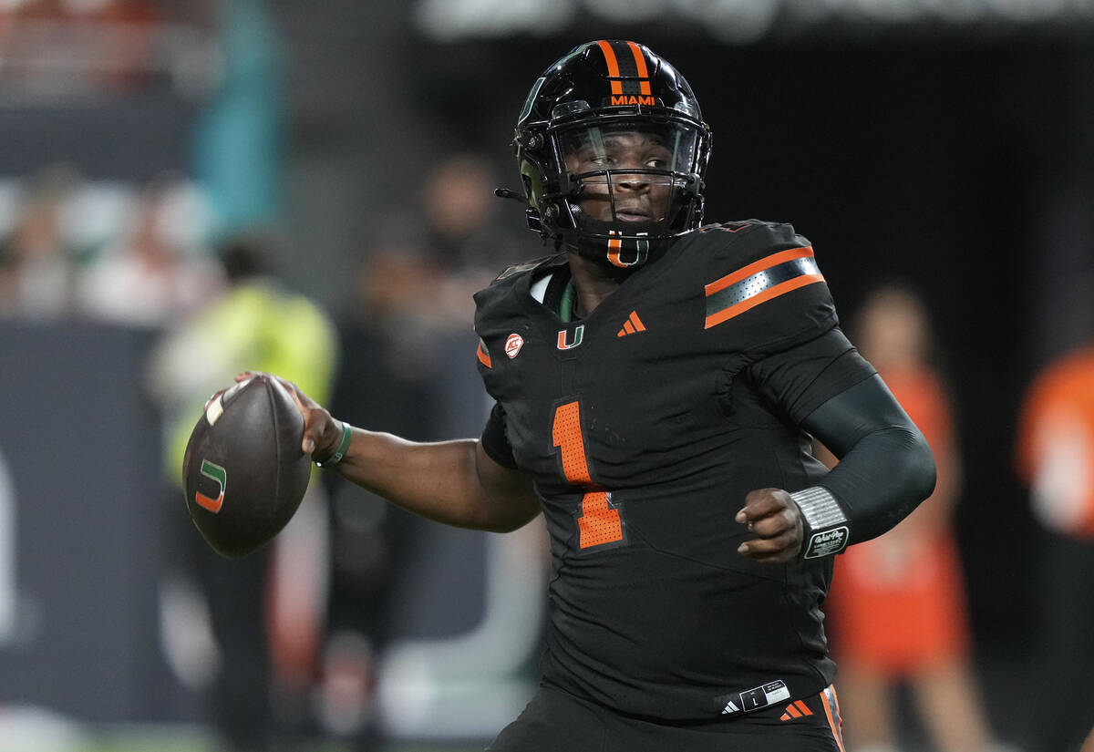 Miami quarterback Cam Ward (1) looks to pass during the first half of an NCAA college football ...