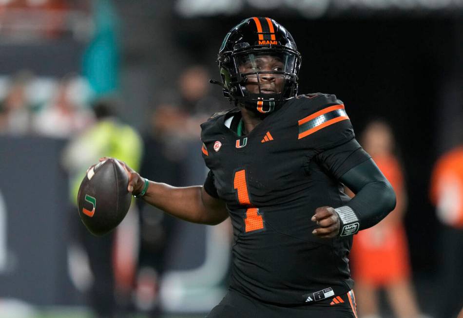 Miami quarterback Cam Ward (1) looks to pass during the first half of an NCAA college football ...