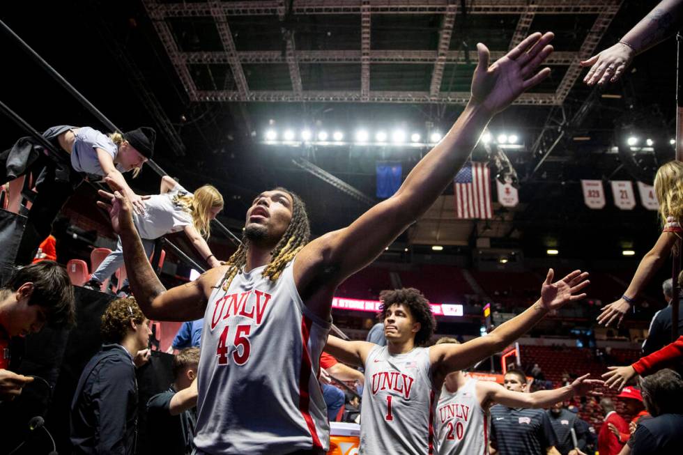 UNLV forward Jeremiah Cherry (45) high-fives fans after winning the college basketball game aga ...