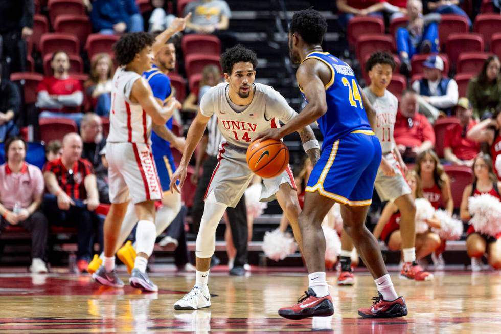 UNLV guard Jailen Bedford (14) watches UC Riverside Highlanders guard Barrington Hargress (24) ...