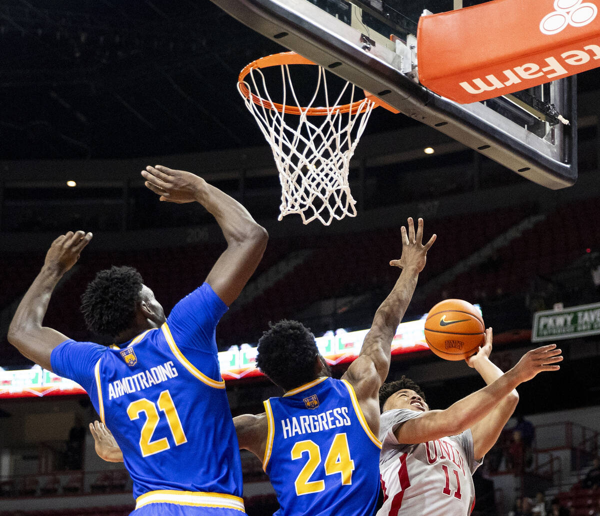 UNLV guard Dedan Thomas Jr. (11) is fouled while attempting a layup during the second half of t ...