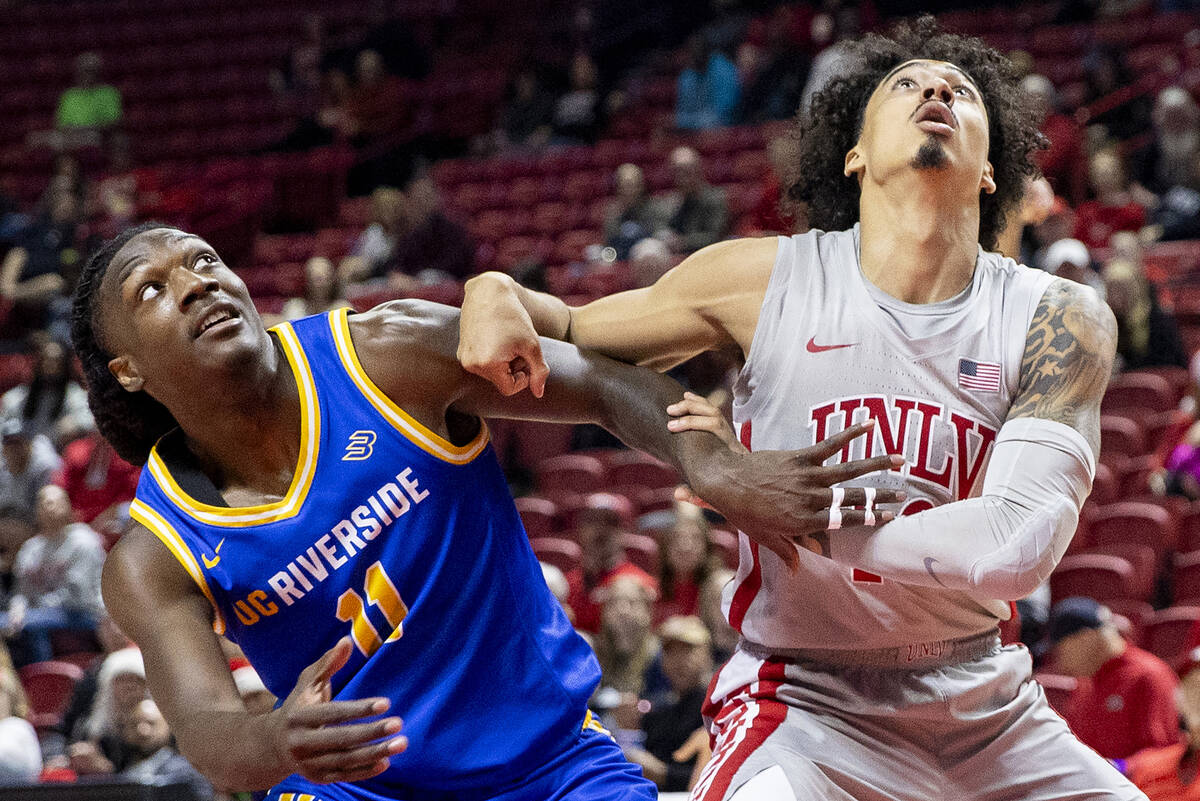 UC Riverside Highlanders guard Nate Pickens (11) and UNLV guard Brooklyn Hicks, right, compete ...