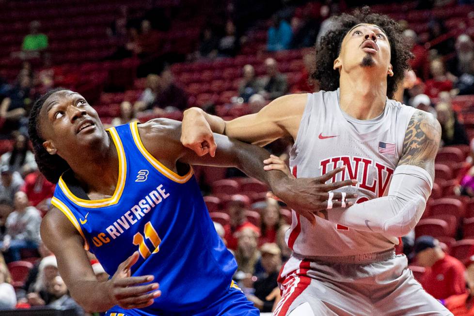 UC Riverside Highlanders guard Nate Pickens (11) and UNLV guard Brooklyn Hicks, right, compete ...