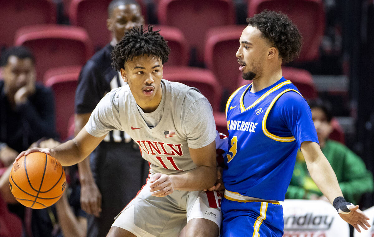 UNLV guard Dedan Thomas Jr. (11) looks to pass UC Riverside Highlanders guard Isaiah Moses (3) ...