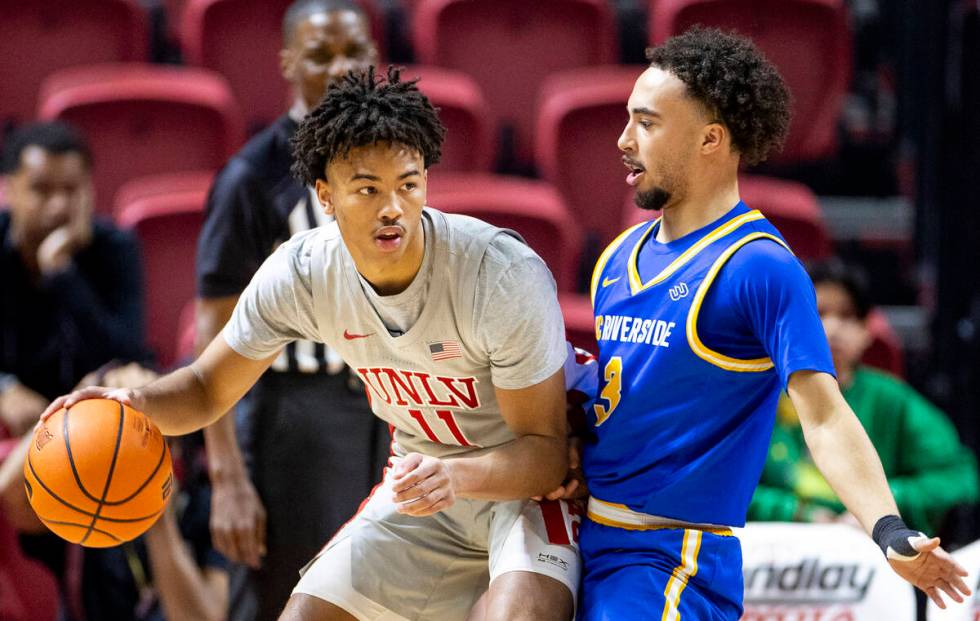 UNLV guard Dedan Thomas Jr. (11) looks to pass UC Riverside Highlanders guard Isaiah Moses (3) ...