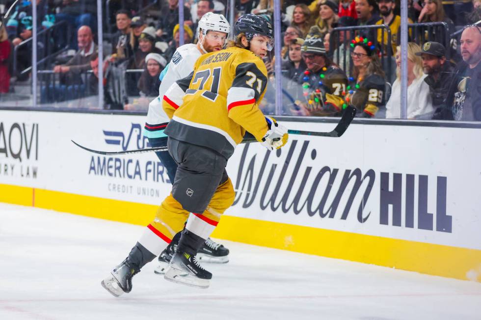 Golden Knights center William Karlsson (71) and Seattle Kraken defenseman Adam Larsson (6) redi ...