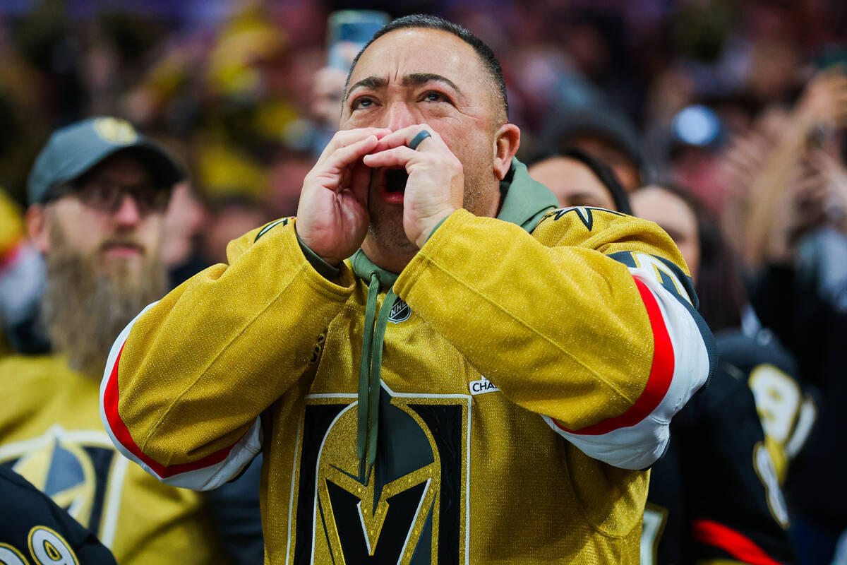 A Golden Knights fan celebrates a goal during an NHL hockey game between the Golden Knights and ...