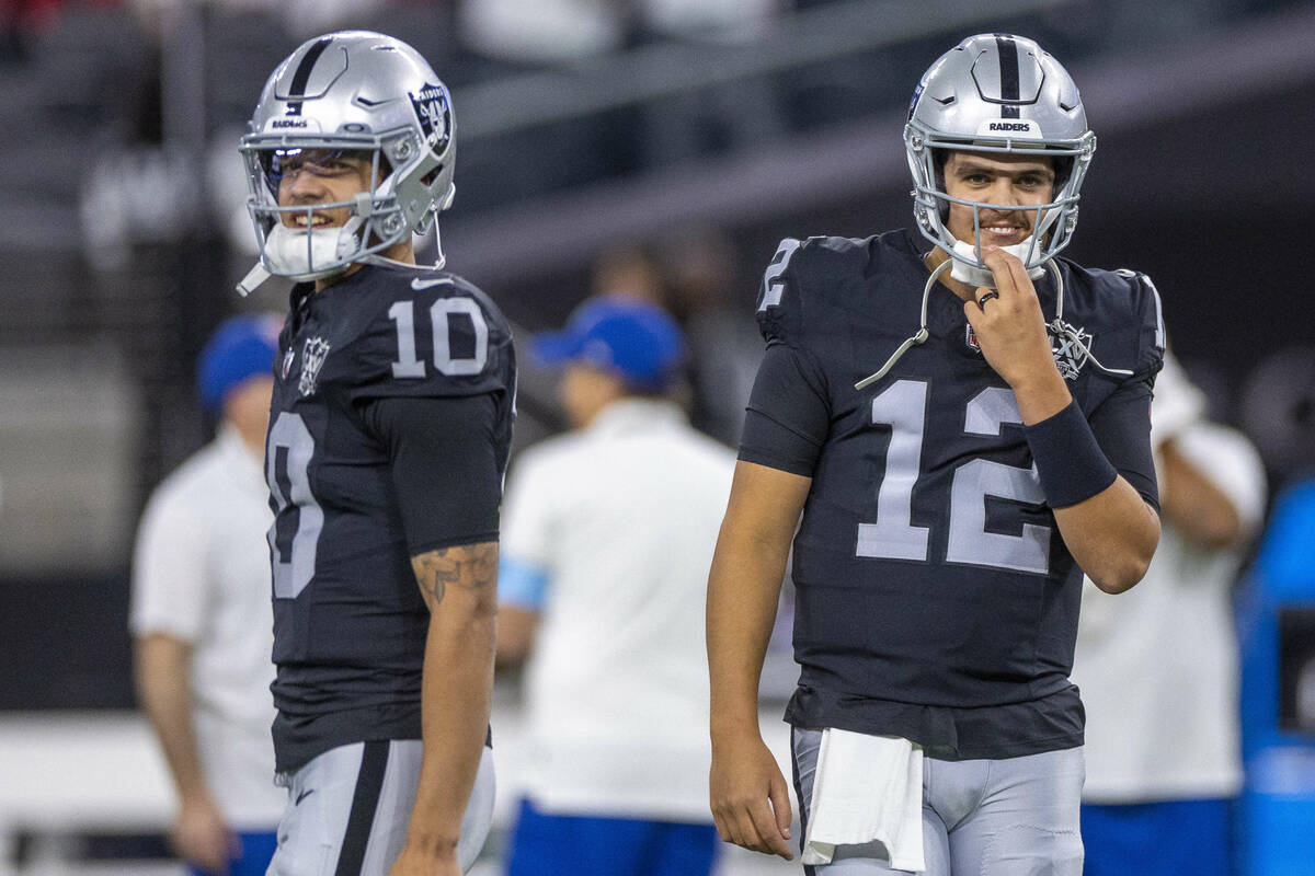 Raiders quarterback Desmond Ridder (10) and quarterback Aidan O'Connell (12) together during wa ...