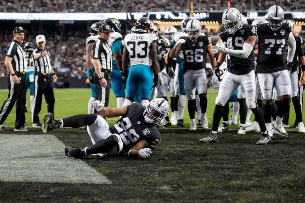 Raiders running back Alexander Mattison (22) rolls into the end zone, scoring a touchdown durin ...