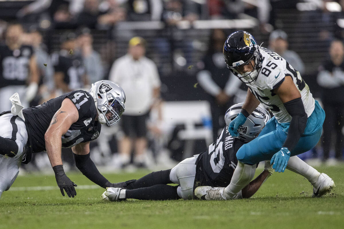 Jacksonville Jaguars tight end Brenton Strange (85) looks for his fumble after being hit by Rai ...