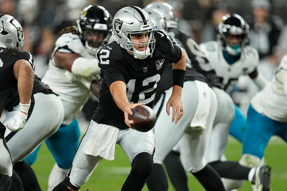 Las Vegas Raiders quarterback Aidan O'Connell hands the all off during the second half of an NF ...