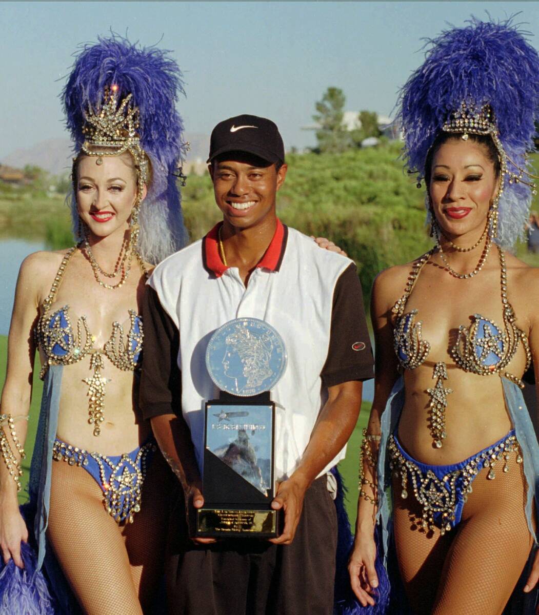 In this Oct. 6, 1996, file photo, Tiger Woods, center, poses after winning his first pro golf t ...