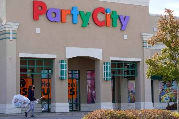 A shopper leaves a Party City store in Vernon Hills, Ill., Thursday, Oct. 15, 2020. (AP Photo/N ...