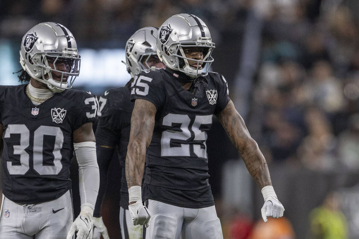 Raiders cornerback Decamerion Richardson (25) flexes between plays with cornerback Darnay Holme ...