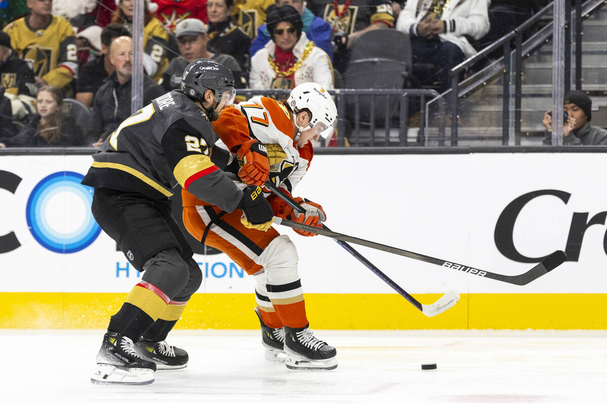 Anaheim Ducks right wing Frank Vatrano (77) fends off Golden Knights defenseman Shea Theodore ( ...