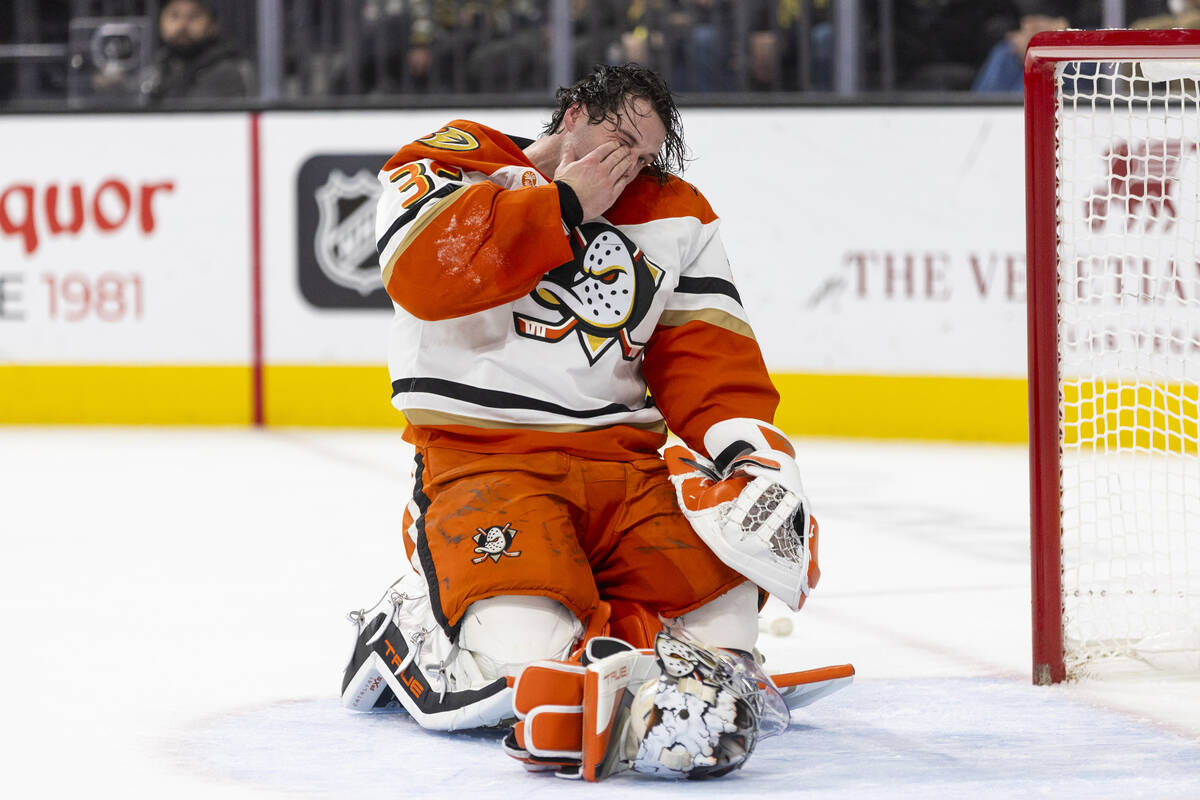 Anaheim Ducks goaltender John Gibson (36) covers his face after taking a stick through his mask ...