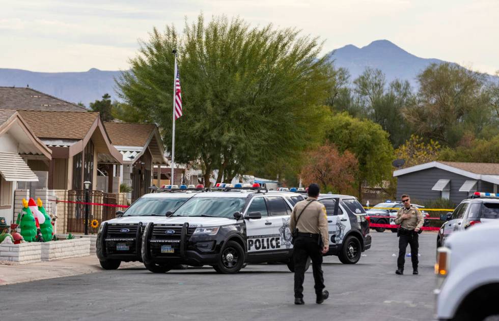 Metropolitan Police Department officers gather around a residence as they take a barricaded sus ...