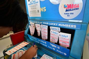 Numbers on tickets for the Mega Millions lottery are selected by a purchaser in Los Angeles, in ...