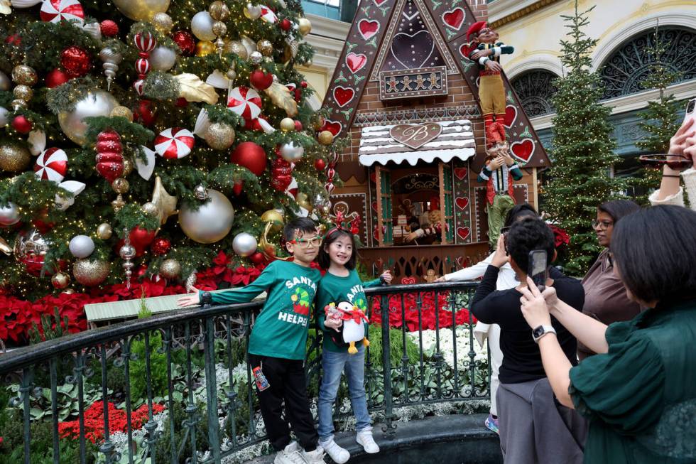 David Quan and Stella Wang, both 8, pose in ‘Twas holiday flower display at Bellagio Con ...