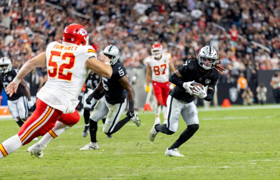 Raiders safety Tre'von Moehrig (7) runs with an intercepted pass during the second half of the ...