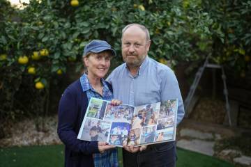 Hazel and David Brief hold a photo book made by their son Yona Brief who died 14 months after H ...