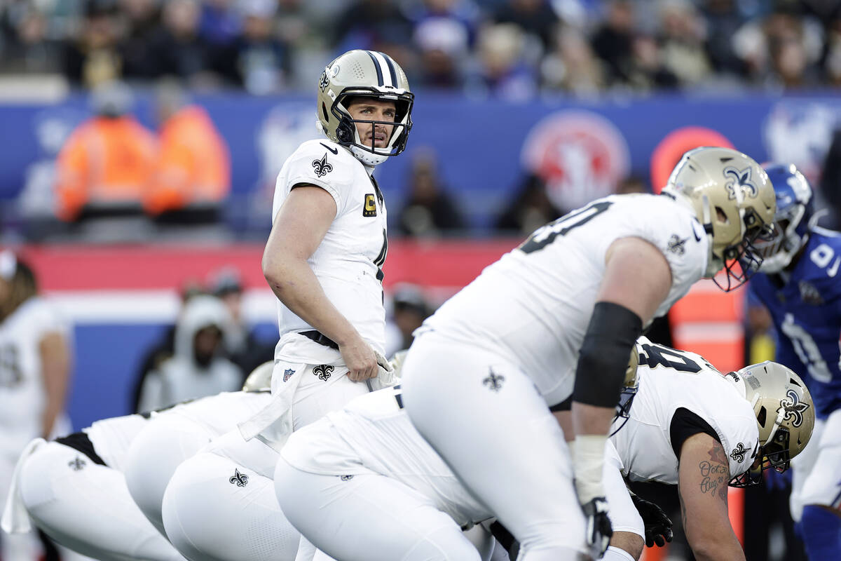 New Orleans Saints quarterback Derek Carr (4) at the line of scrimmage during an NFL football g ...