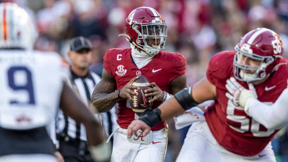 Alabama quarterback Jalen Milroe (4) surveys the field during the first half of an NCAA college ...