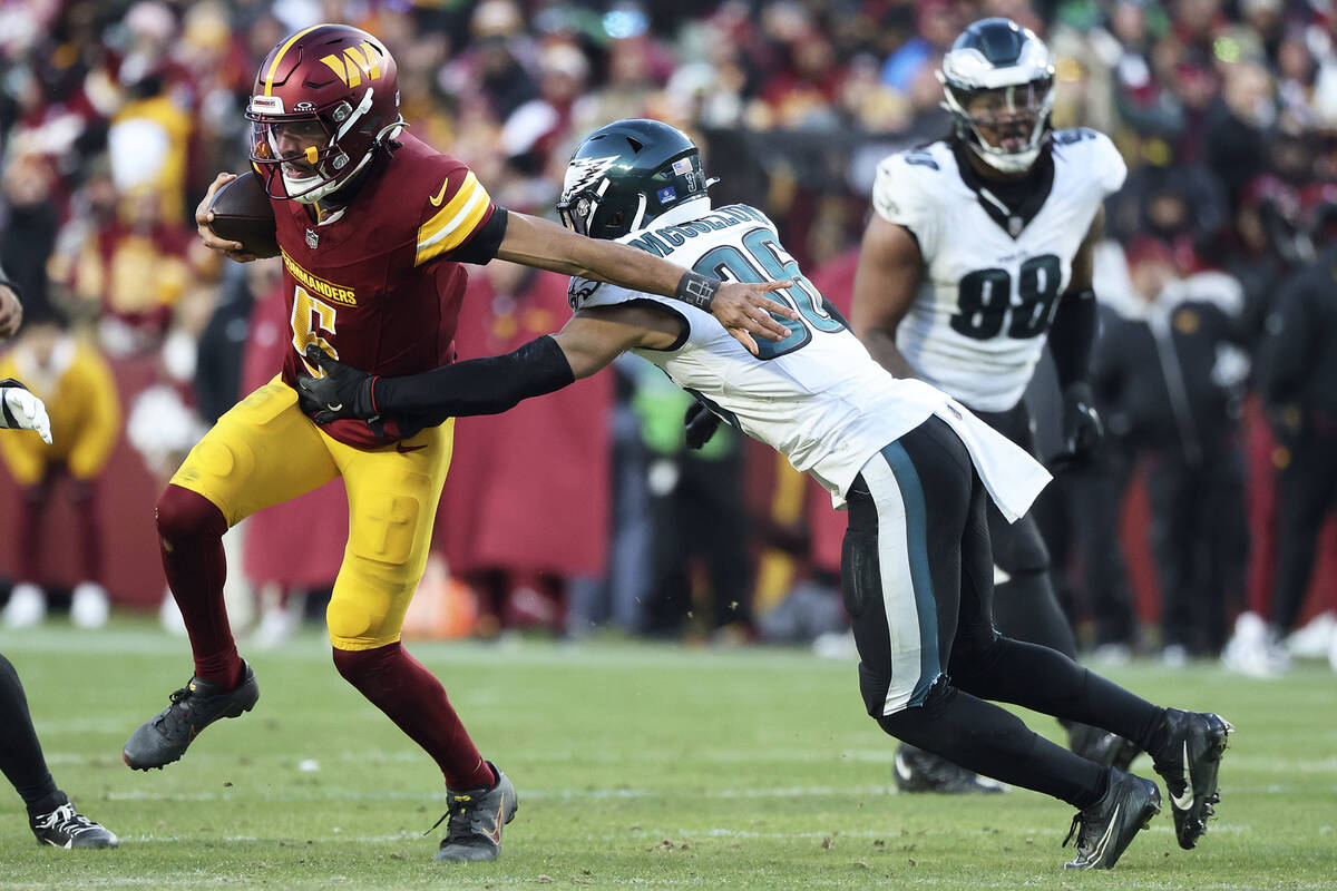 Washington Commanders quarterback Jayden Daniels (5) runs with the ball during an NFL football ...