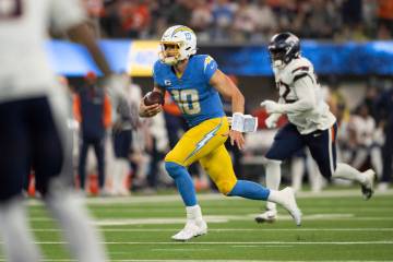 Los Angeles Chargers quarterback Justin Herbert (10) runs with the ball during an NFL football ...