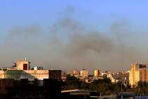 Smoke rises from the area around the International Airport following an airstrike, as seen from ...