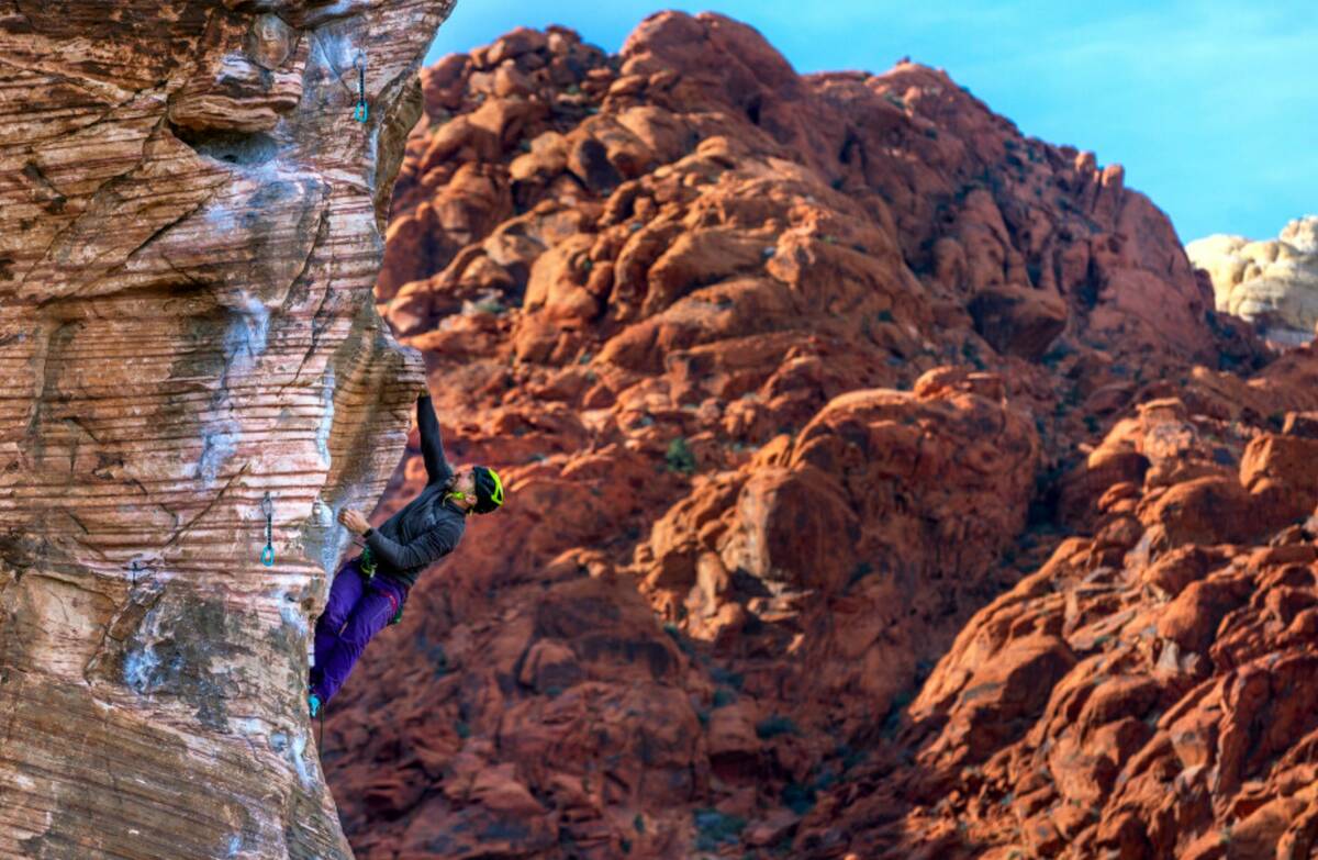 Rock climber Clark Eising of Las Vegas works his way up a route on a large boulder in Calico Ba ...