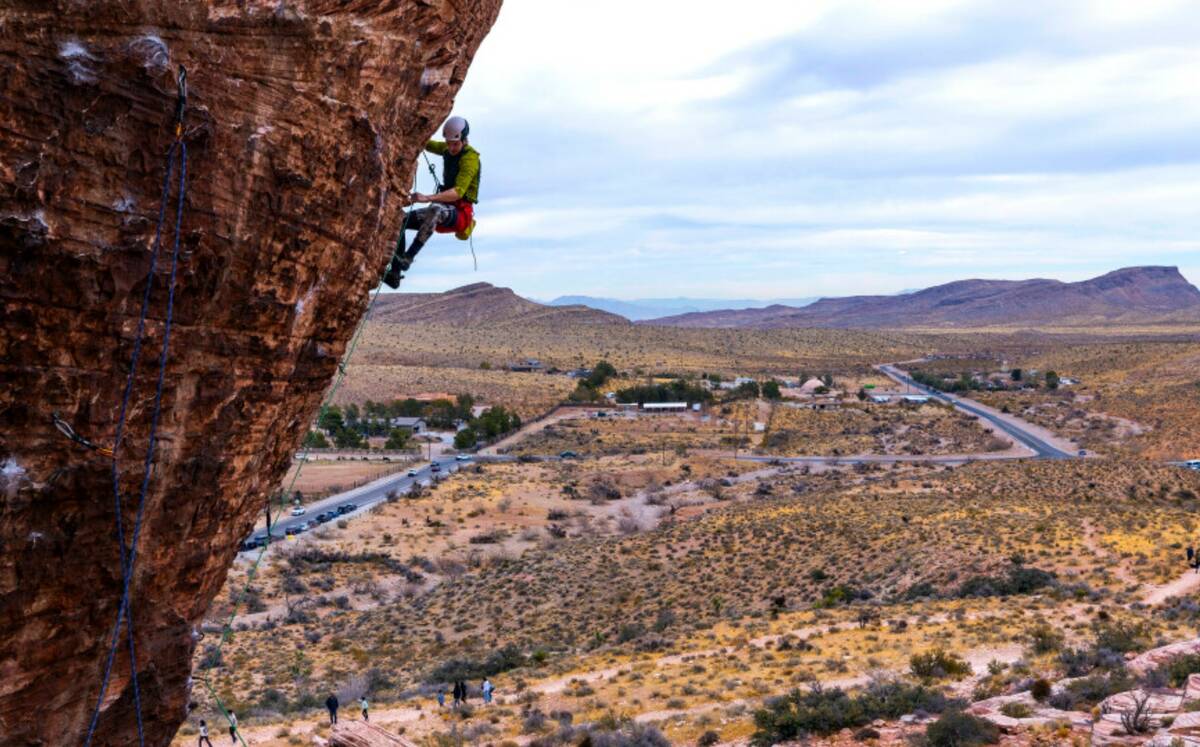 Rock climber Jacob Campbell of Nanaimo, B.C. works his way up a large boulder in Calico Basin o ...