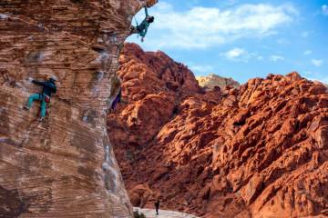 Jack Nelson of Orlando, above, works his way up the "caustic" route on a large boulder in Calic ...