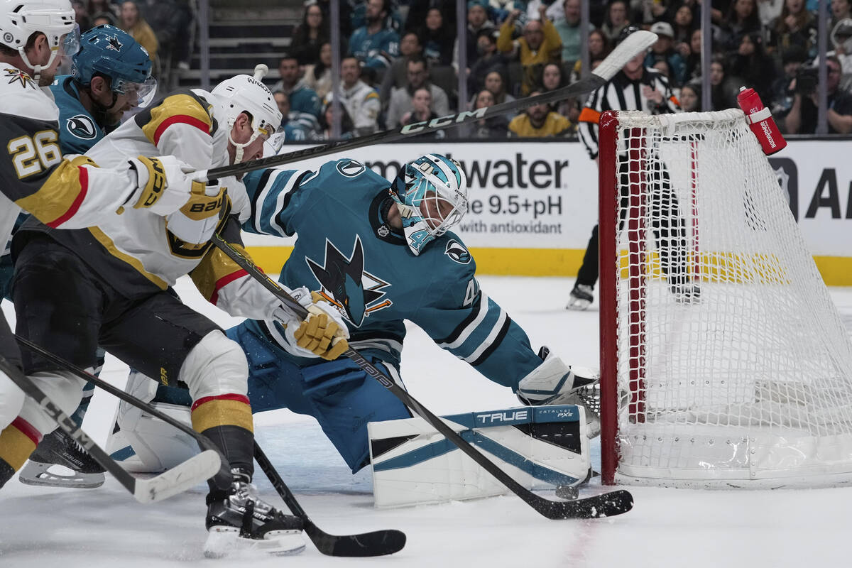 San Jose Sharks goaltender Alexandar Georgiev, front right, stops a shot by Vegas Golden Knight ...