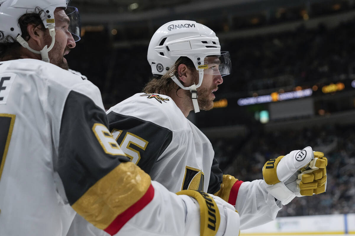 Vegas Golden Knights defenseman Noah Hanifin, right, celebrates with right wing Mark Stone, lef ...