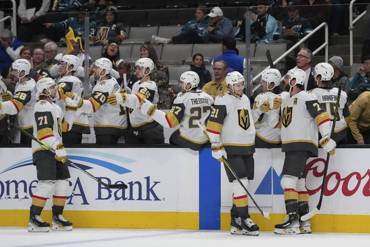 Vegas Golden Knights center Brett Howden (21) celebrates with defenseman Alex Pietrangelo (7) a ...