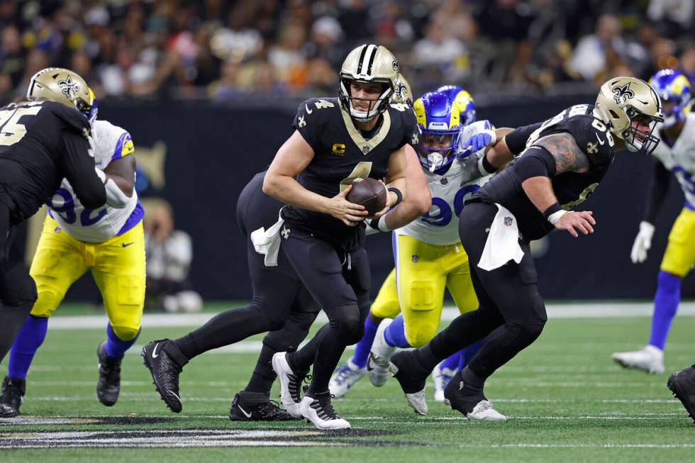 New Orleans Saints quarterback Derek Carr (4) looks to pass during an NFL football game against ...